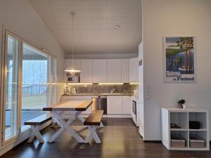 a kitchen with a table and a dining room at Paris Beach in Saarijärvi