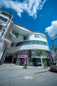a building on a street with a car parked in front at Hotel Tropical in Corozal