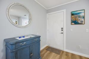 a blue cabinet in a room with a mirror at 8A Amelia Landings Condo in Fernandina Beach