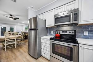 a kitchen with a stainless steel refrigerator and microwave at 8A Amelia Landings Condo in Fernandina Beach +30 photos
