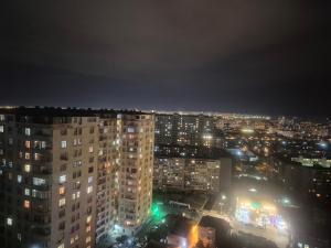 a view of a city at night with lights at Jasmin Park in Baku
