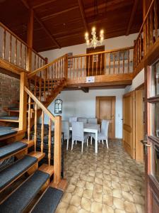 a dining room with a table and a staircase at Gemütliches kleines Zimmer in Jerrishoe +3 photos