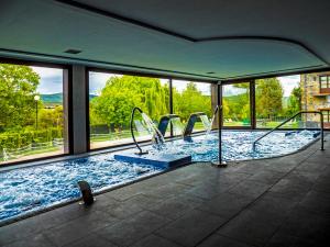 a large swimming pool with a view of the mountains at Casas Green Ordesa in Aínsa