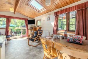 a dining room with a wooden table and chairs at 2 Bed in Lynton oc-riverl in Lynmouth