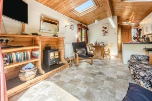 a living room with a fireplace in a log cabin at 2 Bed in Lynton oc-riverl in Lynmouth +18 photos