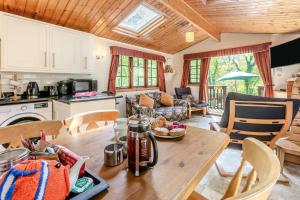 a kitchen and living room with a wooden table at 2 Bed in Lynton oc-riverl in Lynmouth