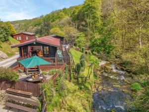 a house on a hill next to a river at 2 Bed in Lynton oc-riverl in Lynmouth