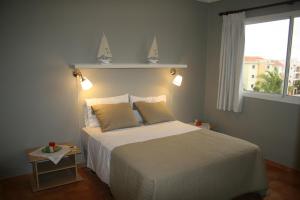 a bedroom with a white bed and a window at Seven beaches Palmeral in Punta Cana +8 photos