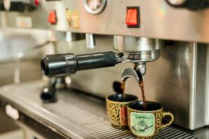 a coffee machine pouring coffee into two coffee cups at The Trail Head in South Fork