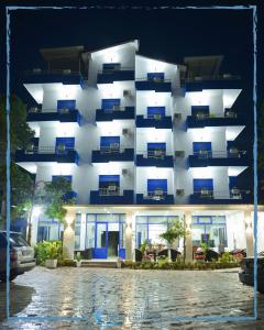 a building with a lit up facade at night at Hotel BlueBalcony in Golem