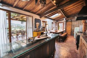 a kitchen with a bar with a view at Terra Lodge in Ericeira