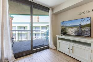 a living room with a large window and a flat screen tv at Harbour Place 510 in Gulf Shores