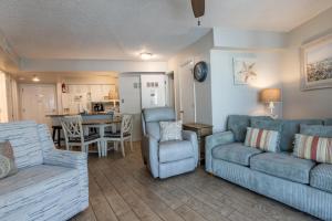 a living room with a couch and a table at Harbour Place 510 in Gulf Shores