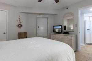 a white bedroom with a bed and a mirror at Harbour Place 510 in Gulf Shores +28 photos