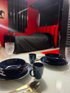 a table with blue plates and silverware on a table at Love room location de 15h a 17h in Wattignies
