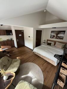 a large room with a bed and a couch at Tiny's Herberg in Woerden