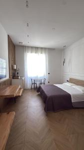 a bedroom with a large bed and a table at La Dea Fuoco in Torre del Greco