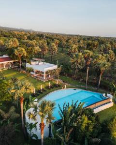 an aerial view of a resort pool with palm trees at Palm Springs Bali Dive Resort in Tulamben