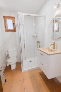 a bathroom with a shower and a toilet and a sink at Siente Cazorla Alojamientos in Cazorla +17 photos