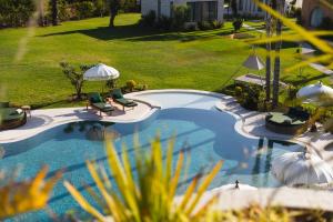 an overhead view of a swimming pool with chairs and umbrellas at Yin Hotel & Spa in Marrakesh