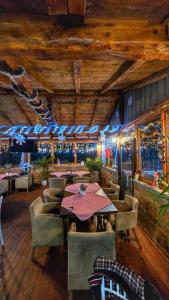 a dining room with a table and some chairs at Wooden Cabin 1 with Pool Access - Bate Bole Resort in Ohrid +14 photos