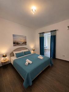 a bedroom with a large bed with two towels on it at Apartments Vista Muo 2026 NEWLY RENOVATED in Kotor +38 photos