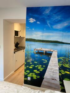 a mural of a dock on a lake with lilies at Natalia 2 in Mrągowo