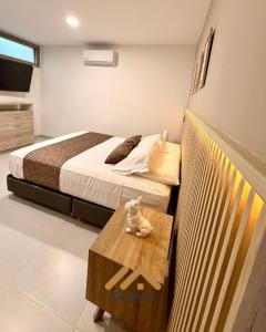 a bedroom with a bed and a table with a stuffed animal at Casa Martina premiun in Buga
