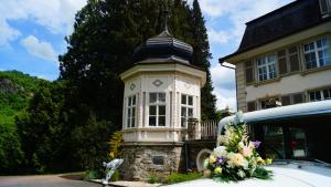 a clock tower in front of a house at Landsitz Kammerburg - Villa in Lorch am Rhein