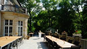 a group of tables and chairs on a patio at Landsitz Kammerburg - Villa in Lorch am Rhein