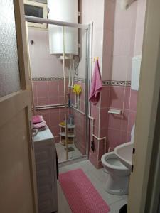 a pink bathroom with a toilet and a sink at Apartman Markovic in Vranje