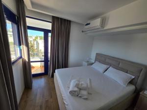 a hotel room with a bed with towels on it at Hotel BlueBalcony in Golem