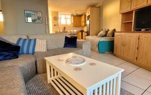 a living room with a couch and a table at Scottburgh Views 707 Seafront Apartment in Scottburgh