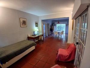 a bedroom with a bed and a table and a desk at Casa Quinta Marie Rose in Mercedes +86 photos