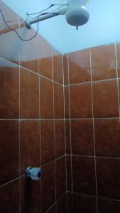 a shower with a light on a tiled wall at Valle Dorado Residence in Colcapirhua +24 photos