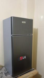 a large black refrigerator sitting in a room at Valle Dorado Residence in Colcapirhua