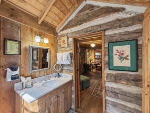 a bathroom with a sink and a mirror at Melrose Cabin in Highlands +20 photos