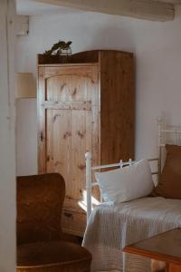 a bedroom with a bed and a wooden door at Axatorpsgården in Trelleborg