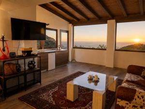 a living room with a couch and a table at Jardines de Ifonche in Ifonche +22 photos