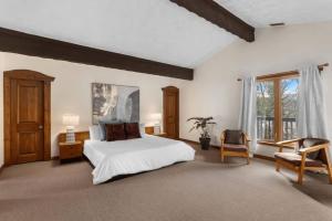 a bedroom with a white bed and a window at Genteman Manor Private Indoor Pool Sauna & Lake in Sainte-Agathe-des-Monts