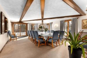 a dining room with a table and chairs at Genteman Manor Private Indoor Pool Sauna & Lake in Sainte-Agathe-des-Monts