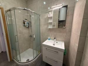 a bathroom with a shower and a sink and a mirror at Sail Haven in Vari