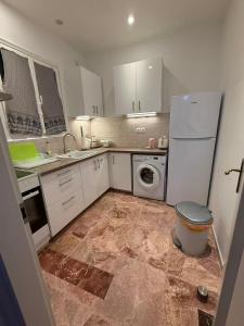 a kitchen with a refrigerator and a washing machine at Sail Haven in Vari