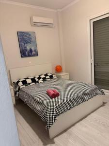 a bedroom with a black and white bed with a red pillow at Sail Haven in Vari