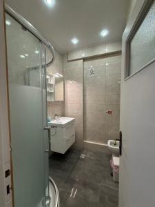 a bathroom with a shower and a sink and a toilet at Sail Haven in Vari