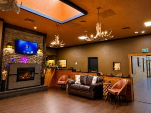 a living room with a couch and a fireplace at Quality Inn Fort Frances in Fort Frances