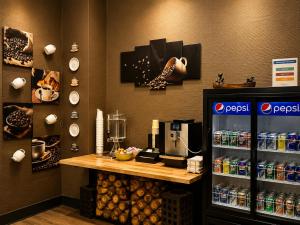 a coffee shop with a counter and a coffee machine at Quality Inn Fort Frances in Fort Frances