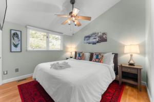 a bedroom with a white bed and a ceiling fan at 826 Wilson Road in Highlands