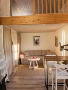 a living room with a couch and a table at Villa Söderläget in Laholm +10 photos