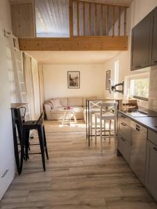 a kitchen and living room with a table and chairs at Villa Söderläget in Laholm